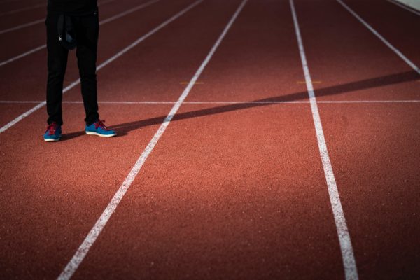 A person standing on a running track