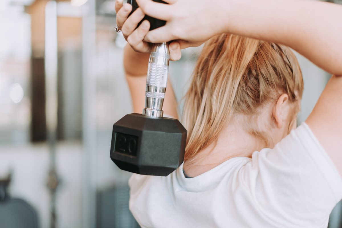 A woman carrying a dumbell